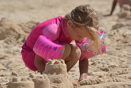 girl building sand castle thumbnail