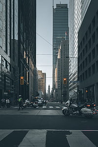 white and black touring motorcycle on street near high-rise buildings thumbnail