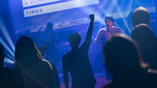 man holding microphone on stage thumbnail