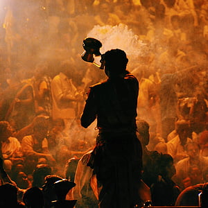 man holding cup with smoke facing men thumbnail