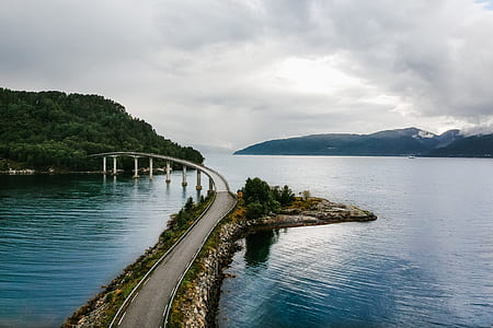 gray concrete bridge connecting two islands taken at daytime thumbnail