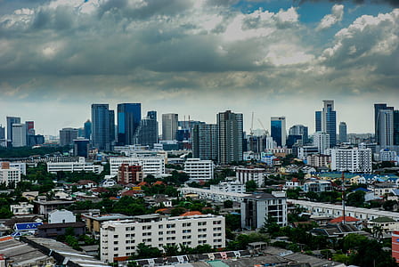 white concrete building under cloudy sky thumbnail