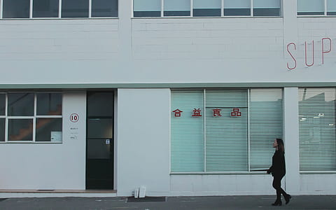 woman walking beside sidewalk thumbnail