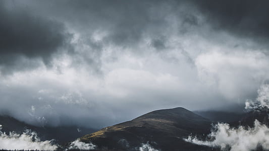 hill under cloudy sky thumbnail