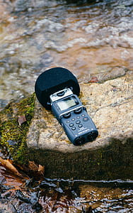 black digital device on rock thumbnail