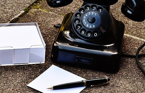 black twist pen beside black roraty telephone thumbnail