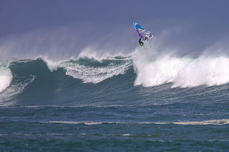 person ride-on surfboard over sea wave thumbnail