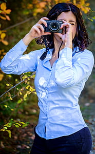 woman holding camera thumbnail