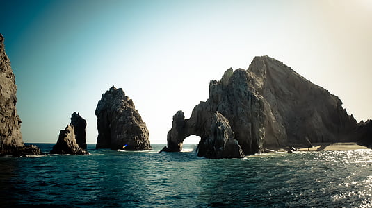 rock formation beside body of water thumbnail