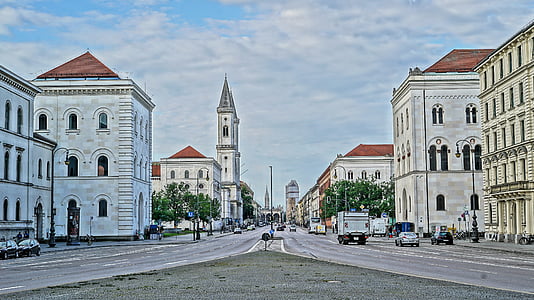vehicles near the buildings at daytime thumbnail