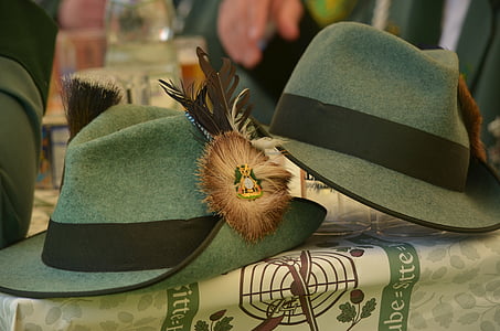 two brown-and-grey trilby caps on table thumbnail