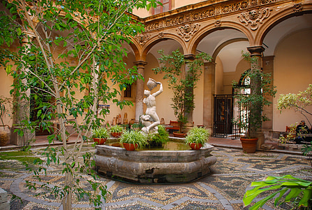 fountain and green plants in patio area at daytime thumbnail