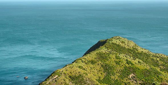 aerial photo of cliff beside body of water thumbnail