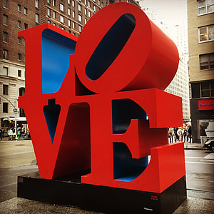 red Love concrete statue near road during daytime thumbnail