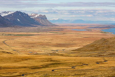 aerial view of brown field under cloudy sky thumbnail