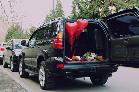 four heart-shaped balloons inside vehicle trunk thumbnail