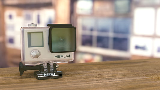 black GoPro Hero4 on brown surface thumbnail