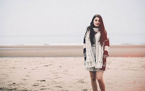 woman standing on brown sand thumbnail