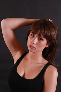 woman in black tank top posing for photo thumbnail