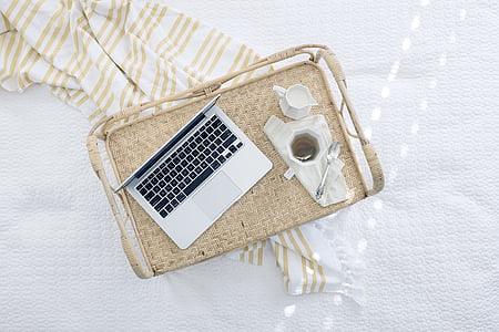 silver laptop computer on top of brown trauy thumbnail