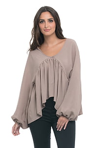 woman wearing brown scoop-neck long-sleeved shirt and black bottoms thumbnail