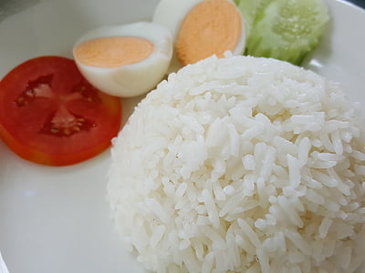 steamed rice beside sliced boiled egg and tomato thumbnail