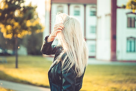 Blonde Woman Playing with Hair Against Sun thumbnail