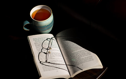 white opened book near mug with coffee thumbnail