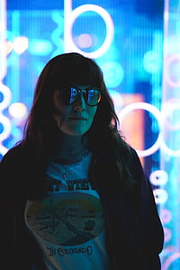 woman in black jacket standing near neon lights thumbnail