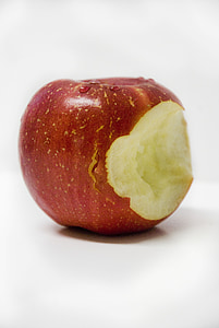 bitten red apple on white tabl thumbnail