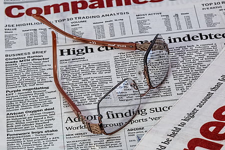 brown framed eyeglasses on newspaper thumbnail
