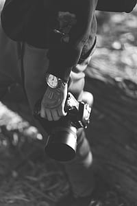 person holding DSLR camera thumbnail