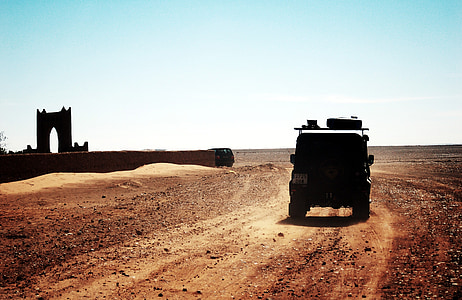 black vehicle speeding n road at daytime thumbnail