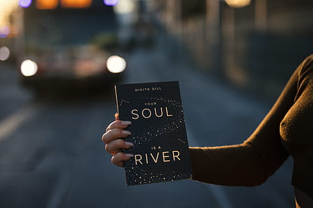 woman holding Soul is a River book thumbnail