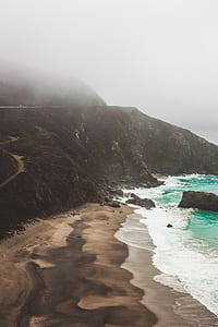 black rock formation beside sea thumbnail