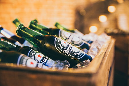 Heineken glass bottles on brown wooden rack thumbnail