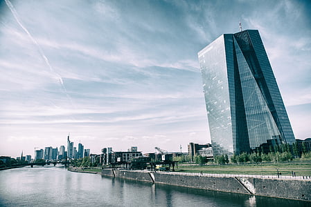 architectural photography of building leaning towards body of water thumbnail