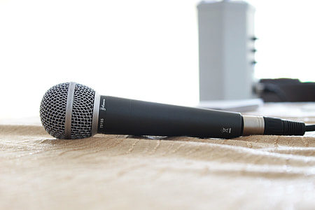 black and gray corded microphone on brown textile thumbnail