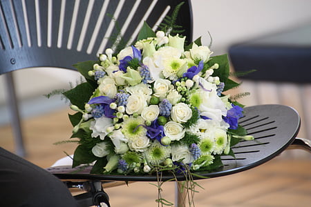 bouquet of white flowers on black chair thumbnail