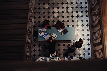 three person sitting beside wooden table thumbnail