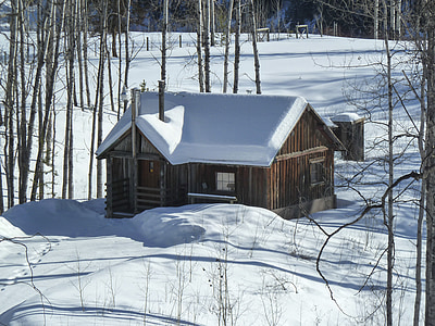 brown and white house surrounded with snow thumbnail