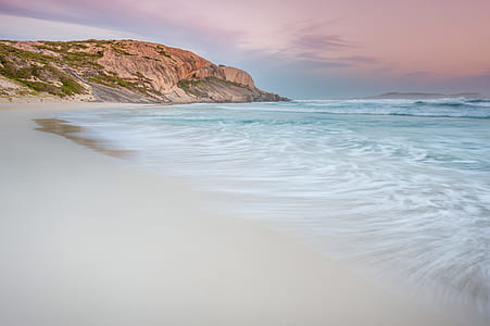 white beach shore under gray sky thumbnail