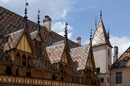 brown and black building under blue sky thumbnail