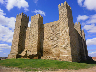 low-angle photography of gray castle under cloudy sky thumbnail