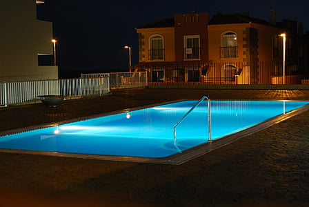 lighted swimming pool during nighttime thumbnail