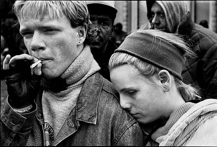 grayscale photo of man smoking near woman thumbnail