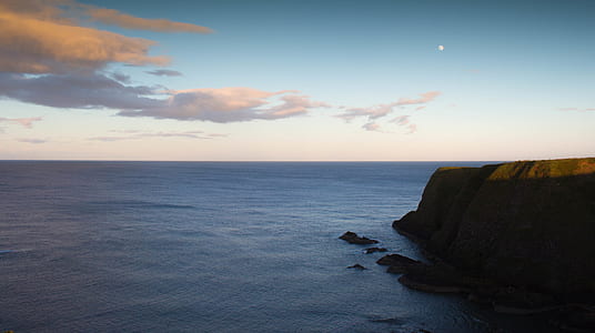 photo of cliff beside body of water thumbnail