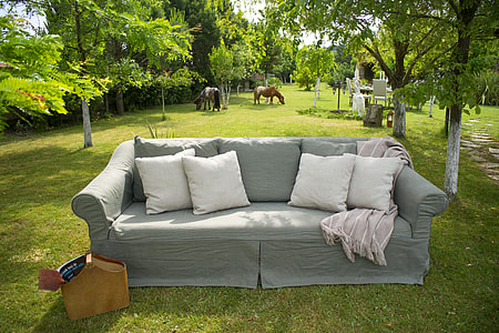 gray fabric sofa and four white throw pillows thumbnail