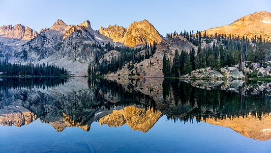 body of water and mountains during daytime thumbnail
