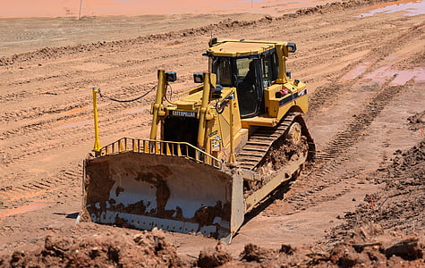 yellow heavy equipment on soil field thumbnail
